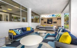 a living room with blue couches and yellow pillows at New Apartment in Houston in Houston