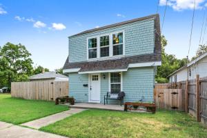 a blue house with a fence in a yard at Cute Barnette only 5mins-Silos, 7mins-Baylor in Waco