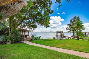 a house on the shore of a body of water at Lake Howard Hideway in Winter Haven