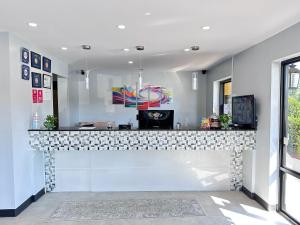 a kitchen with a counter with a counter top at Deluxe Inn - Fayetteville I-95 in Fayetteville