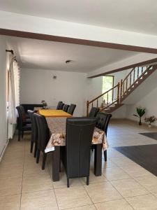 a dining room with a table and chairs and a staircase at Cabana Mario in Albac