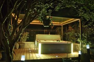 a jacuzzi tub in a backyard at night at Les Tanalis - Chambres d'hôtes & Gîte in Gurs