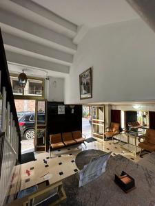 a living room with chairs and a table at Hôtel National in Al Hoceïma