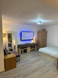 a bedroom with a bed and a desk and a tv at Stylish Studio flat - Watford Junction - Harry potter in Watford