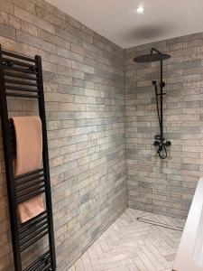uma casa de banho com um chuveiro em azulejo e um toalheiro. em Modern 4 bedroom entire house 8 Sleep em Basildon