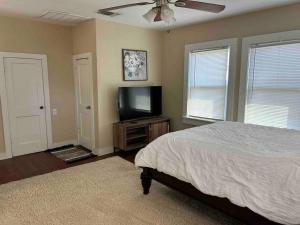 a bedroom with a bed and a flat screen tv at Near Trade Days and the Square and Pets welcome in Weatherford