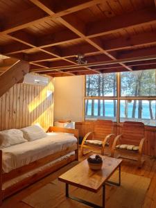 普孔的住宿－Magma Lodge, Pucon，一间卧室配有一张床、两把椅子和一张桌子