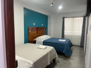Giường trong phòng chung tại Hotel Villa Santa Ana