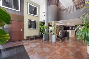 a lobby with plants and a waiting area at O Hotel by LuxUrban in Los Angeles