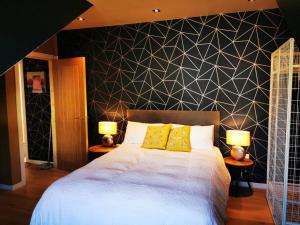 a bedroom with a large bed with two lamps at Luxury Apartment Brighton and South Downs National Park, Free Parking, animals on request - daily fee in Brighton & Hove