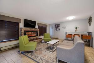 a living room with a couch and chairs and a fireplace at Best Western Bemidji in Bemidji
