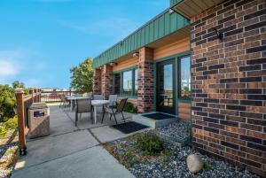 a patio with a table and chairs next to a brick building at Best Western Bemidji in Bemidji