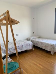 a room with three bunk beds and a ladder at Apartamento Torre Laguna in El Ejido