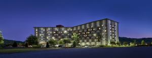 a large building is lit up at night at Harrah's Cherokee Valley River Casino & Hotel in Murphy