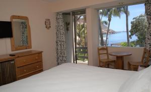 a bedroom with a bed and a view of the ocean at La Concha Beach Hotel & Club in La Paz