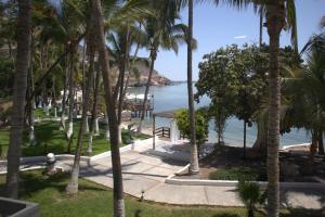 a view of the ocean from a resort with palm trees at La Concha Beach Hotel & Club in La Paz