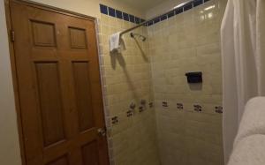 a bathroom with a shower with a shower curtain at La Concha Beach Hotel & Club in La Paz