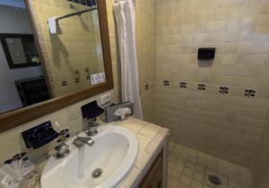 a bathroom with a sink and a shower at La Concha Beach Hotel & Club in La Paz