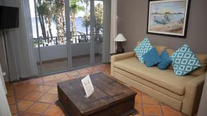 a living room with a couch and a coffee table at La Concha Beach Hotel & Club in La Paz