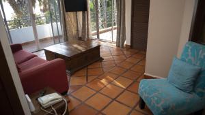 a living room with two chairs and a couch and a table at La Concha Beach Hotel & Club in La Paz
