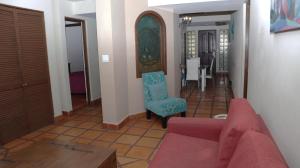 a living room with a couch and a chair at La Concha Beach Hotel & Club in La Paz