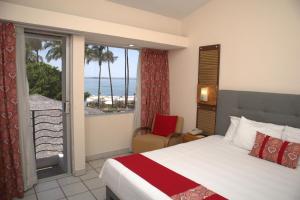 a hotel room with a bed and a view of the ocean at La Concha Beach Hotel & Club in La Paz +37 photos