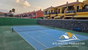 a tennis court in front of a apartment complex at Atlantic Paradise in Costa Del Silencio