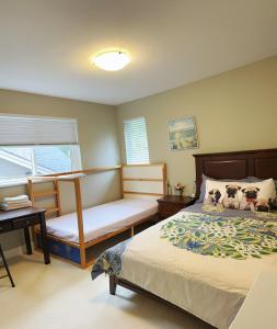 a bedroom with a bed and a desk and a window at Derbyshire House in Coquitlam