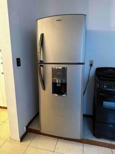 a stainless steel refrigerator in a kitchen next to a stove at Amplia Casa/Residencia a 15 Minutos de playa Miramar y Altama in Tampico