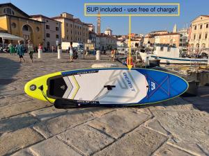 a yellow and blue boat sitting on the ground at Grand Apartment Piran in Piran