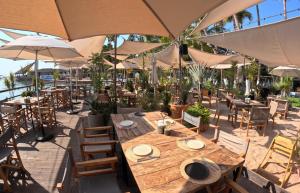a restaurant with tables and chairs and umbrellas at La Concha Beach Hotel & Club in La Paz