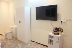 a living room with a tv on a white wall at شقة خاصة للعائلات فقط in Al Madinah