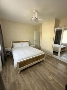 a bedroom with a large bed and a window at Harbour View 49 Urch Street Unit 8 in Geraldton