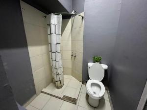 a bathroom with a toilet and a shower at WHOST Hotel y Hostal in Mexico City +30 photos