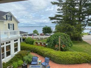 a house with a garden in the front yard at Spouter Inn Bed & Breakfast in Lincolnville