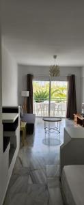 a living room with a piano and a table at Estudio Altamira 128 - Tenerife in Adeje