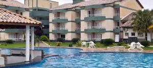 a hotel with a swimming pool in front of a building at Aldeia das Aguas Village in Barra do Piraí