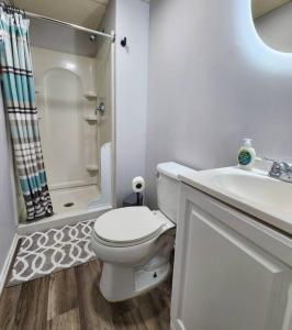 a white bathroom with a toilet and a sink at Old world charm with modern renovation and decor in Springfield