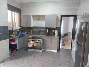 a kitchen with white cabinets and a stove top oven at Villa X15-11 Grand Heights in 6th Of October