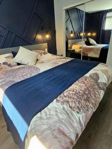 a bedroom with a large bed with a large mirror at Le Calvados in Quebec City