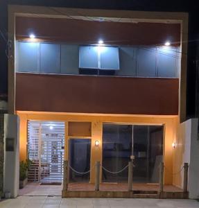 a building with a fence in front of it at Hostel Pajuçara in Maceió