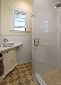 a white bathroom with a sink and a shower at Upscale Downtown Home Walk to Beach shops Bars 2 in Santa Barbara