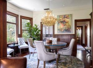 a dining room with a table and chairs and a chandelier at Upscale Downtown Home Walk to Beach shops Bars 2 in Santa Barbara