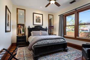 a bedroom with a bed and a large window at Upscale Downtown Home Walk to Beach shops Bars 2 in Santa Barbara