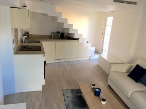 a kitchen and living room with a couch and a table at Duplex Citadelle in Saint-Tropez