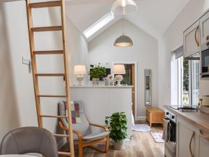 a kitchen and living room with a ladder at Green Acres in Nidd