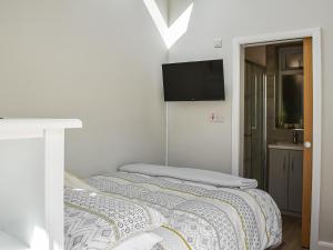 a bedroom with a bed and a flat screen tv at Green Acres in Nidd