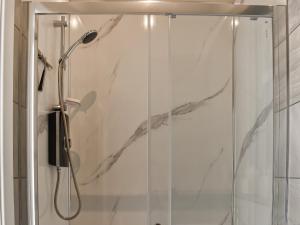 a shower with a glass door in a bathroom at Green Acres in Nidd