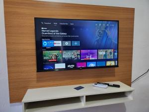 a flat screen tv sitting on top of a wooden wall at Hotel Real Koerich 24h in Rio do Sul