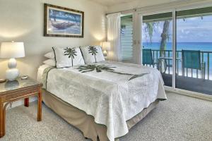 a bedroom with a bed and a view of the ocean at Condos in Kapa'a Sands in Kapaa